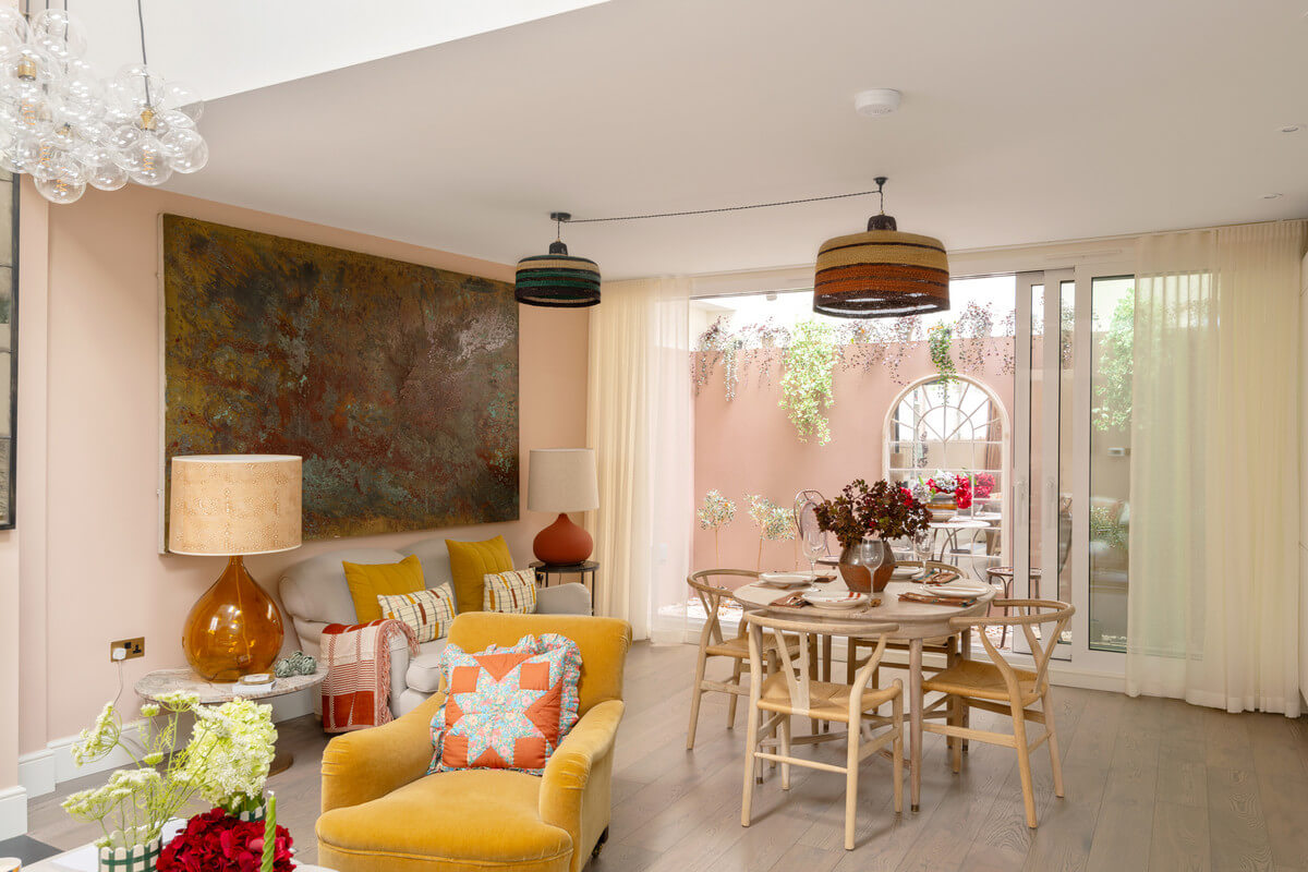 A Light London Maisonette in a Former Artist's Studio 7 open plan living room with pink walls and yellow chair