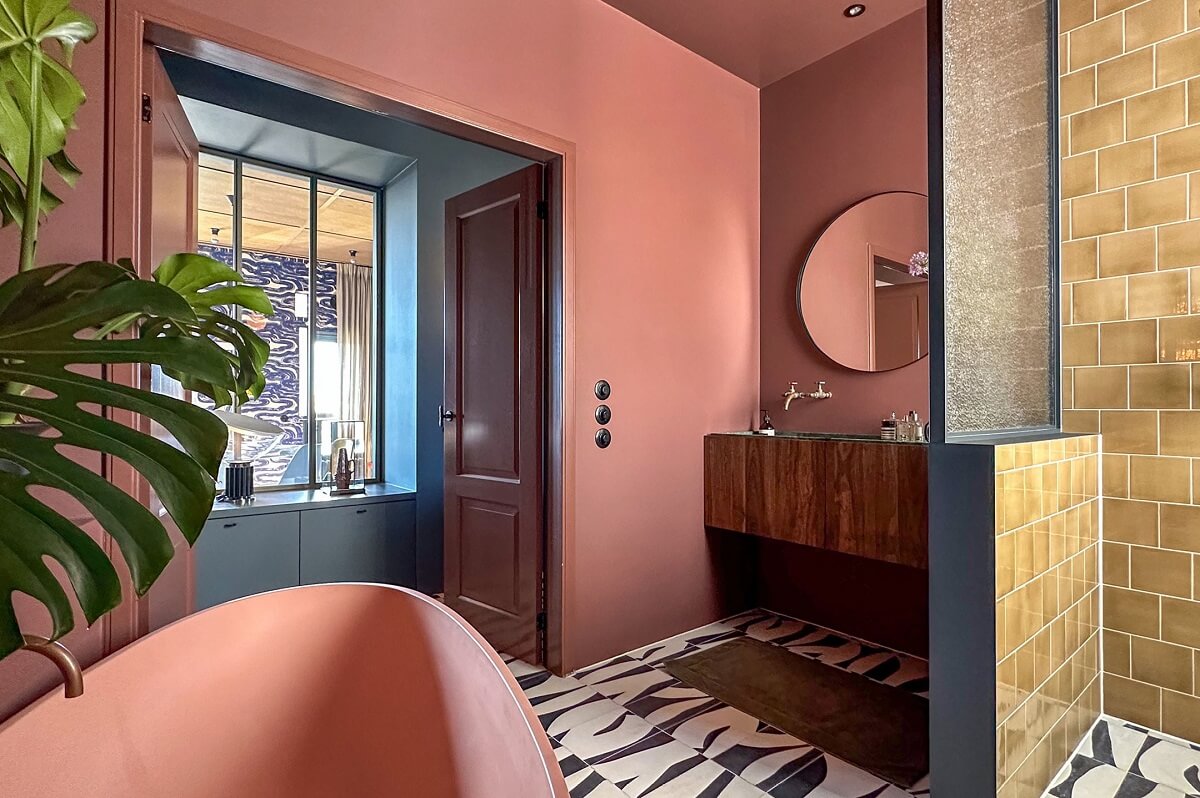 Color and Graphic Design in the Home of a Dutch Interior Stylist 30 pink bathroom with walk in shower and graphic tiles