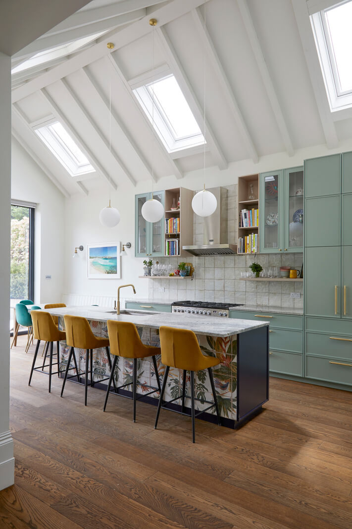 A Colorful London Family Home Renovated by Fraher & Finlay 7 spacious kitchen with pitched ceiling and ochre bar stools