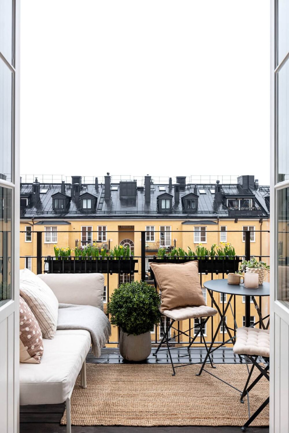 A Stylish Renovated Stockholm Apartment with Built-In Storage 15 balcony with lounge sofa and table nordroom