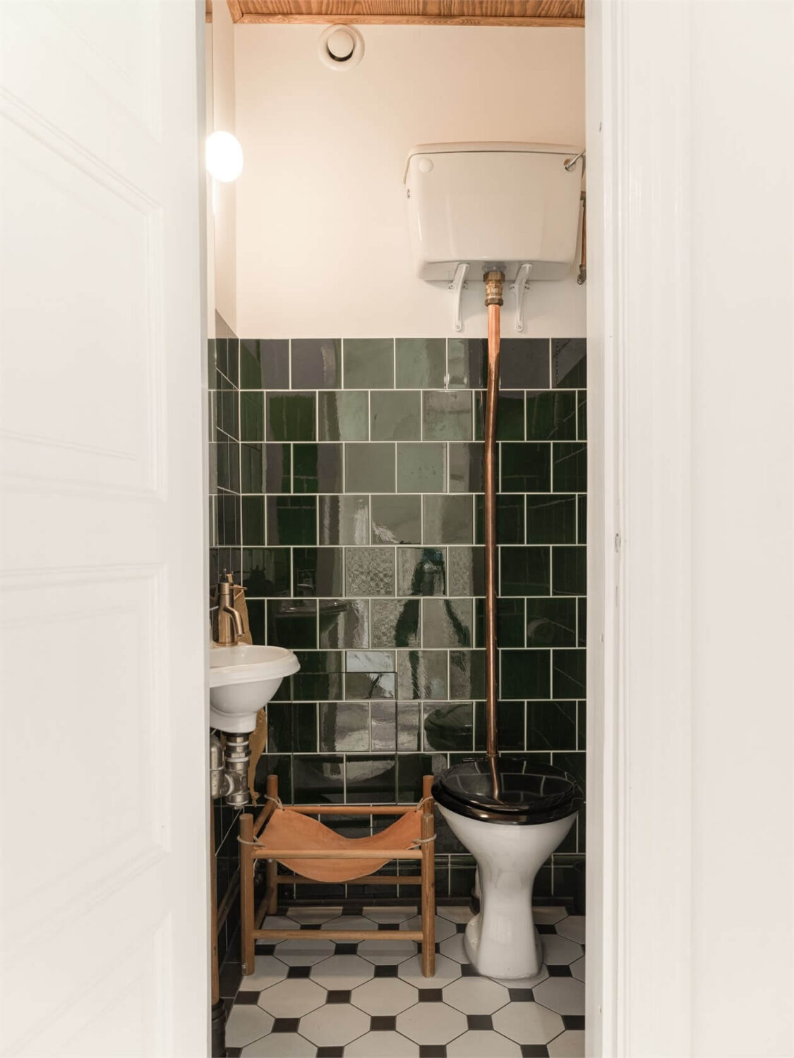 Wooden Details in a Light Duplex Apartment in Sweden 23 bathroom with glossy green tiles nordroom