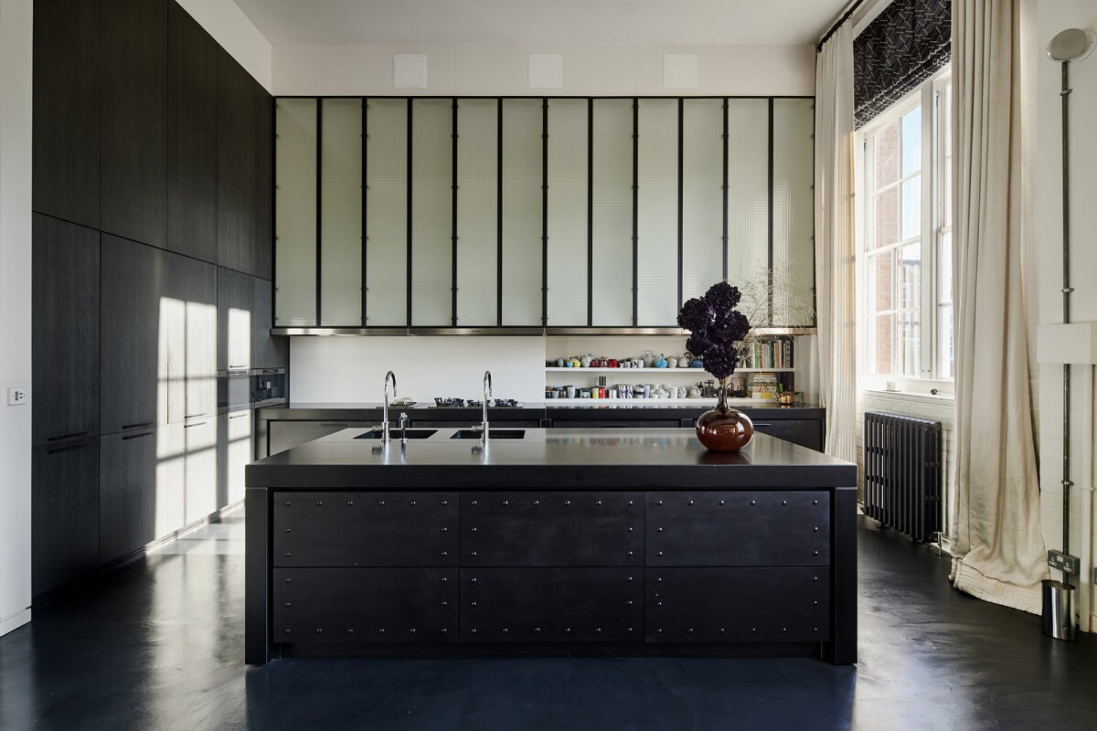 A Monochrome London Loft Filled with Art 13 black kitchen with floor to ceiling cabinets monochrome loft apartment london nordroom