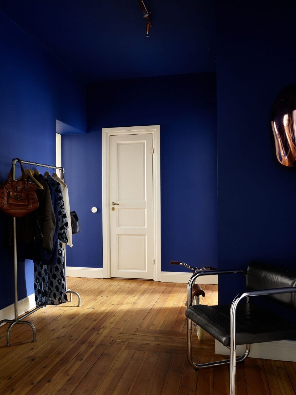 Valspar Color of the Year 2025: Encore 11 blue painted hallway with wooden floor nordroom