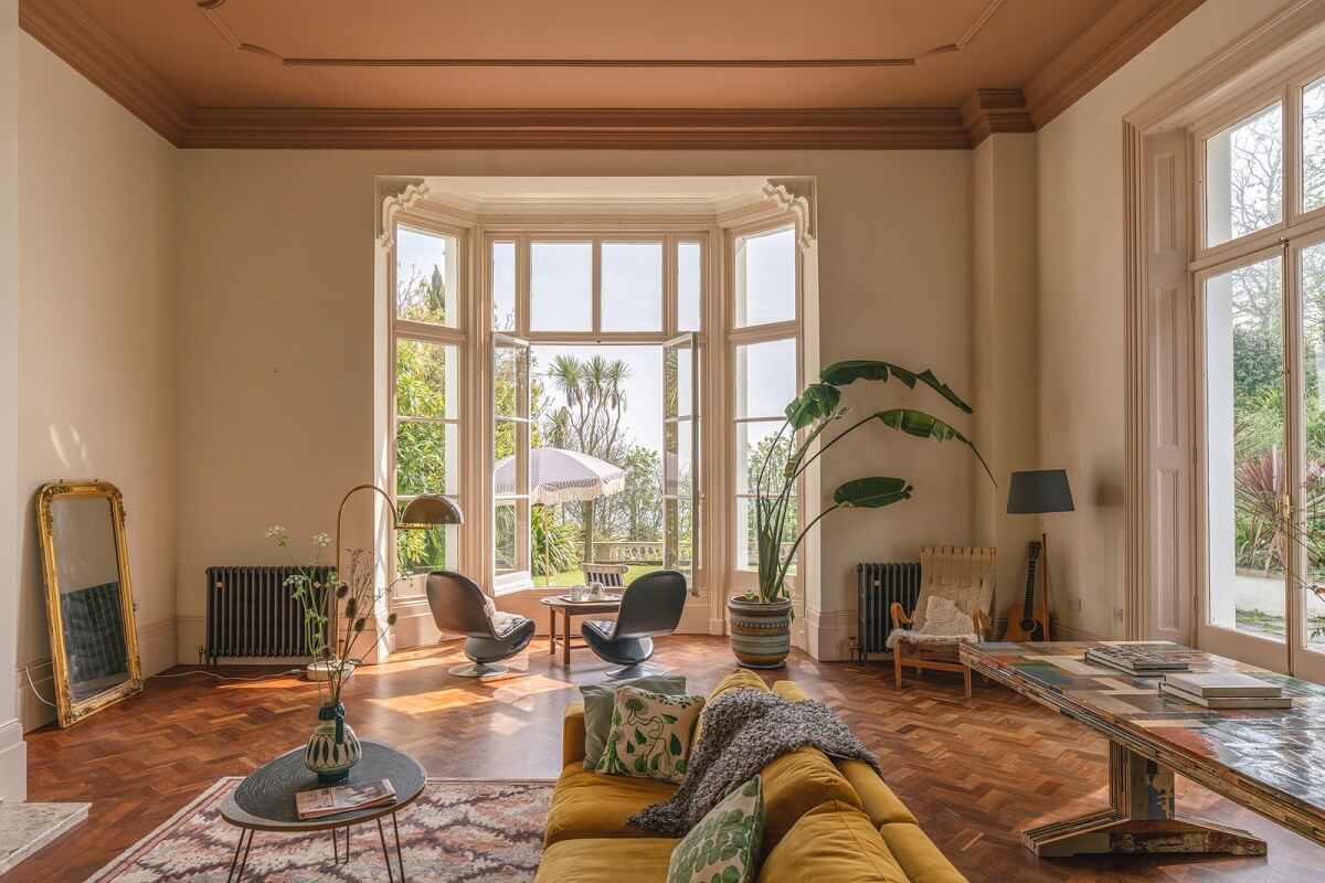 grand living room with bay window painted ceiling and ochre sofa nordroom