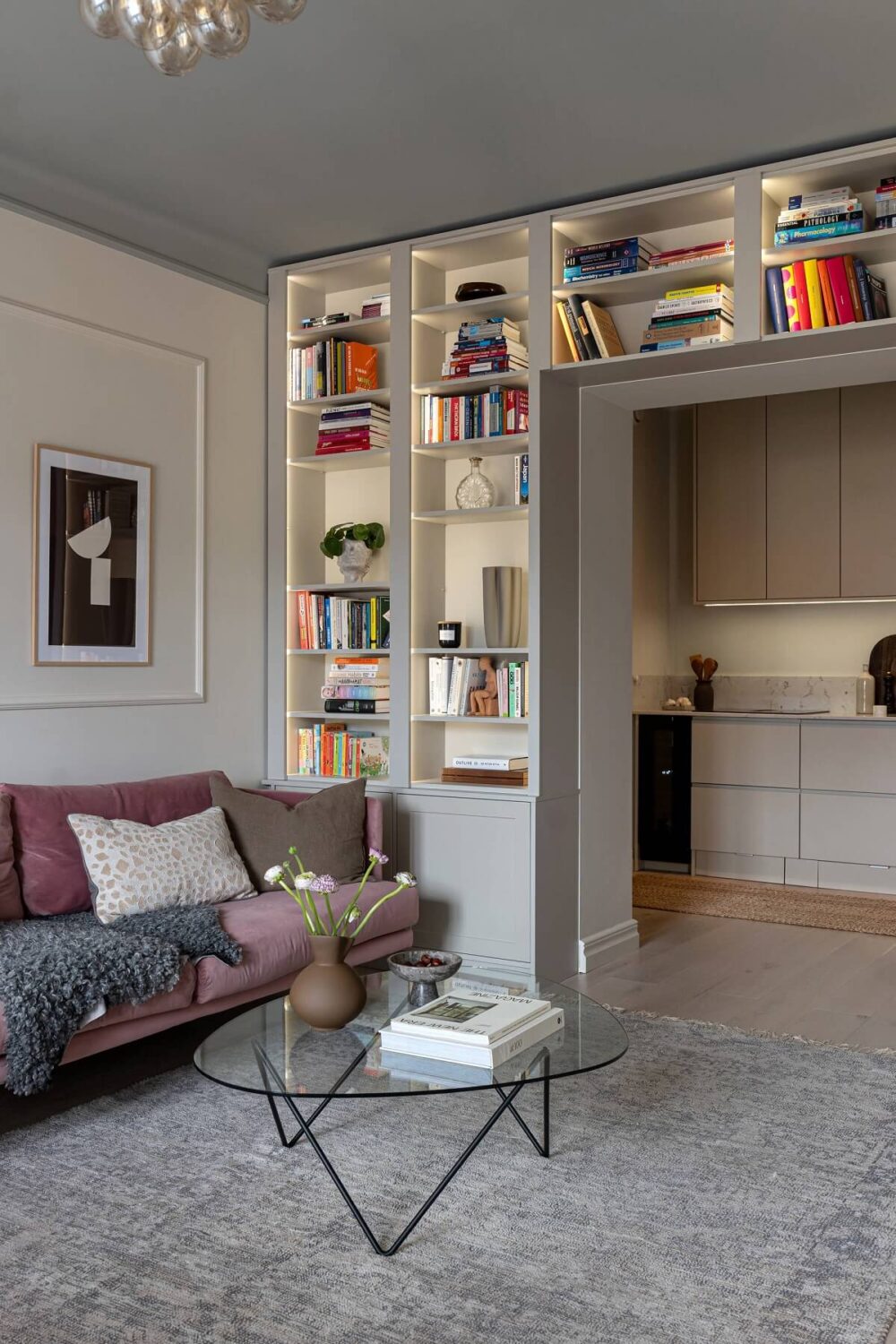 A Stylish Renovated Stockholm Apartment with Built-In Storage 1 gray living room with lighted built in bookshelves