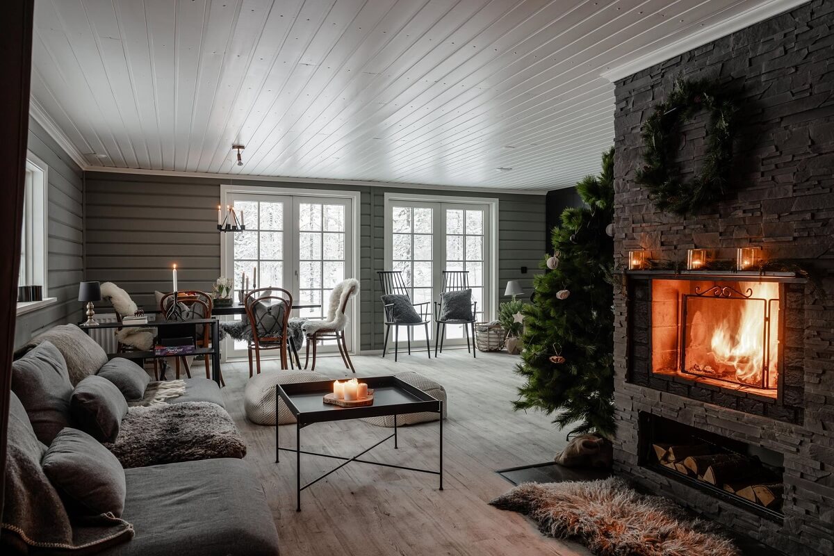 A Gray Swedish Log House Decorated for Christmas 1 gray log house living room with fireplace and christmas decor nordroom
