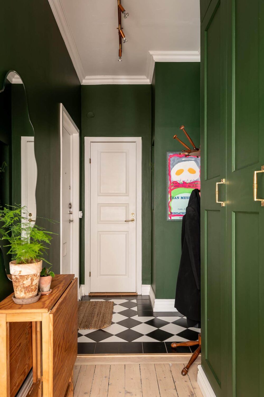 A Turn of the Century Apartment with a Green Kitchen 25 green hallway with black and white floor tiles nordroom