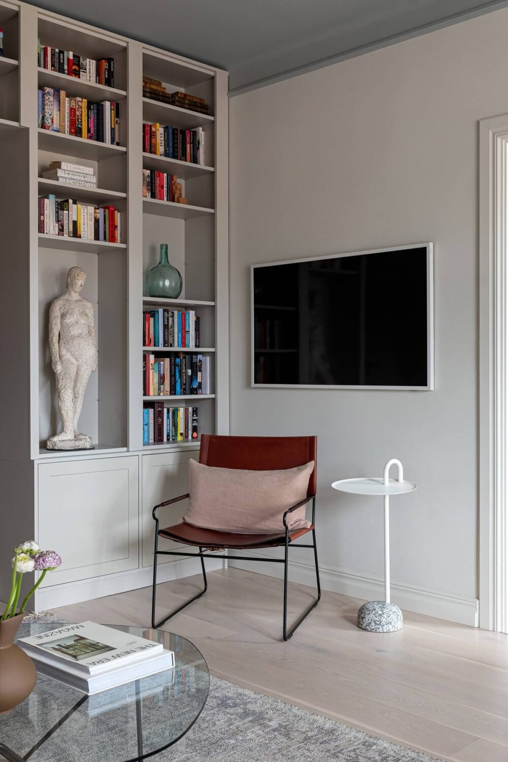 A Stylish Renovated Stockholm Apartment with Built-In Storage 3 light gray living room with bookshelves