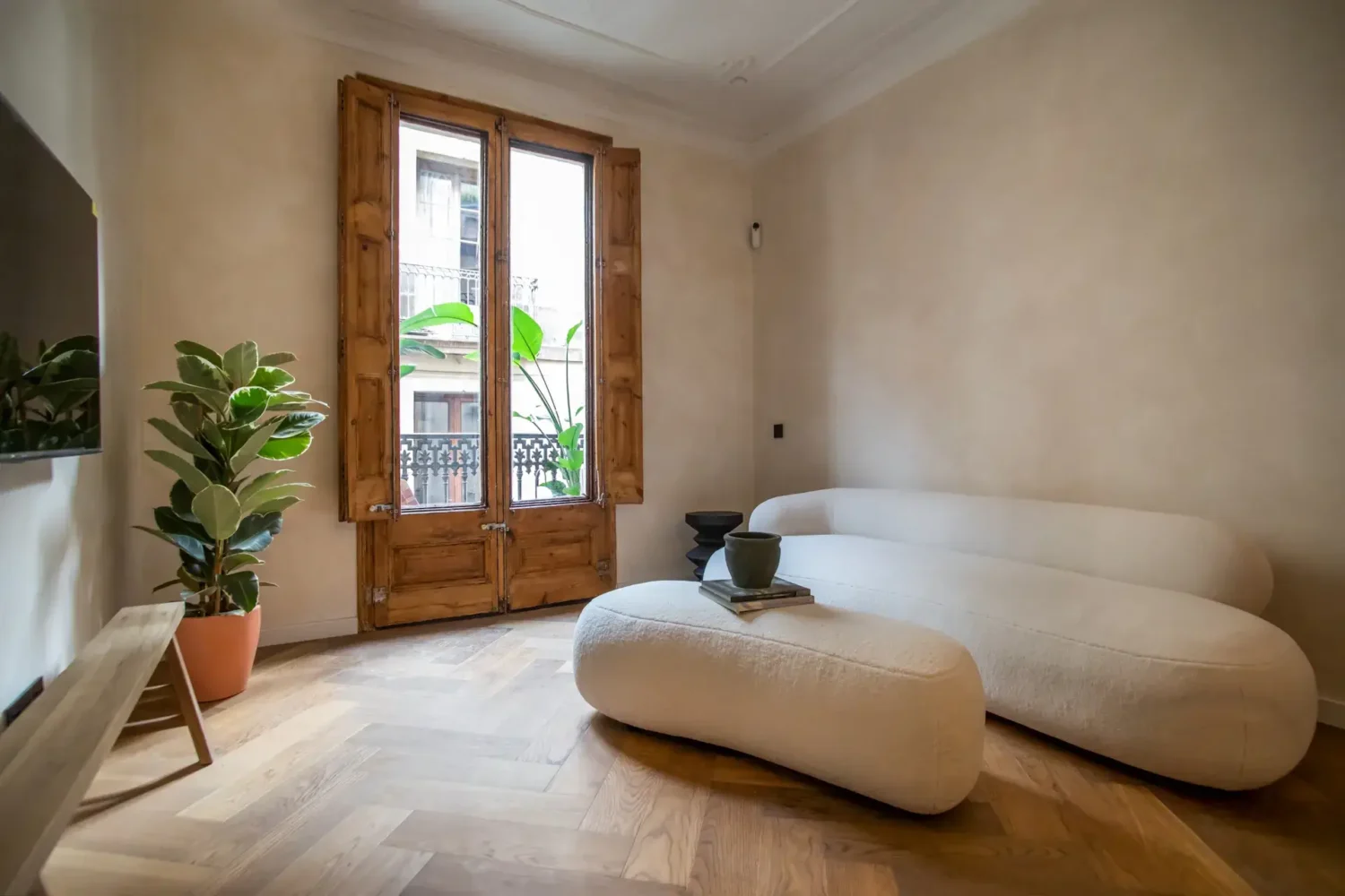 A Serene Apartment in Barcelona's Gothic Quarter 1 living room with old wooden french doors