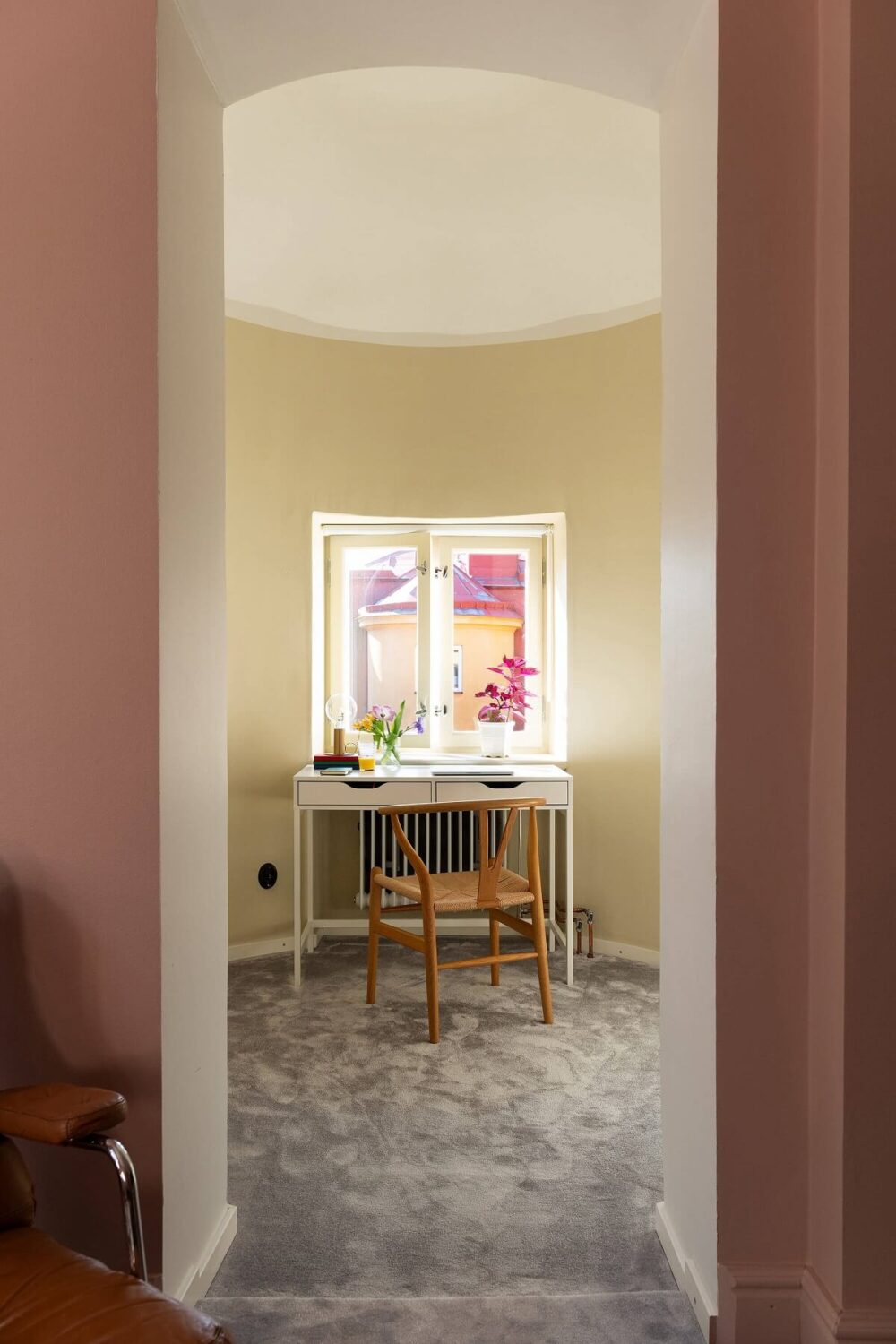 An Elegant Turn-of-the-Century Apartment in Stockholm 21 pastel yellow walls in round room home office nordroom