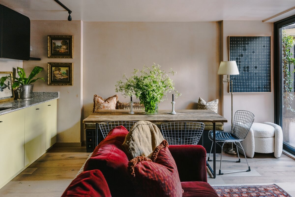 Warm Color Tones in a London Apartment with a Garden 1 small open plan living room and kitchen with dining tabe and red sofa