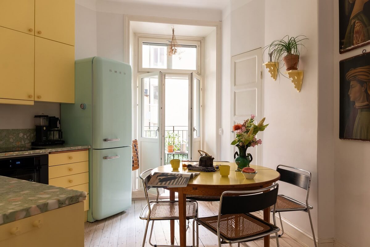 A Swedish Apartment with a Yellow Kitchen 1 yellow kitchen with mint green smeg fridge and round table nordroom