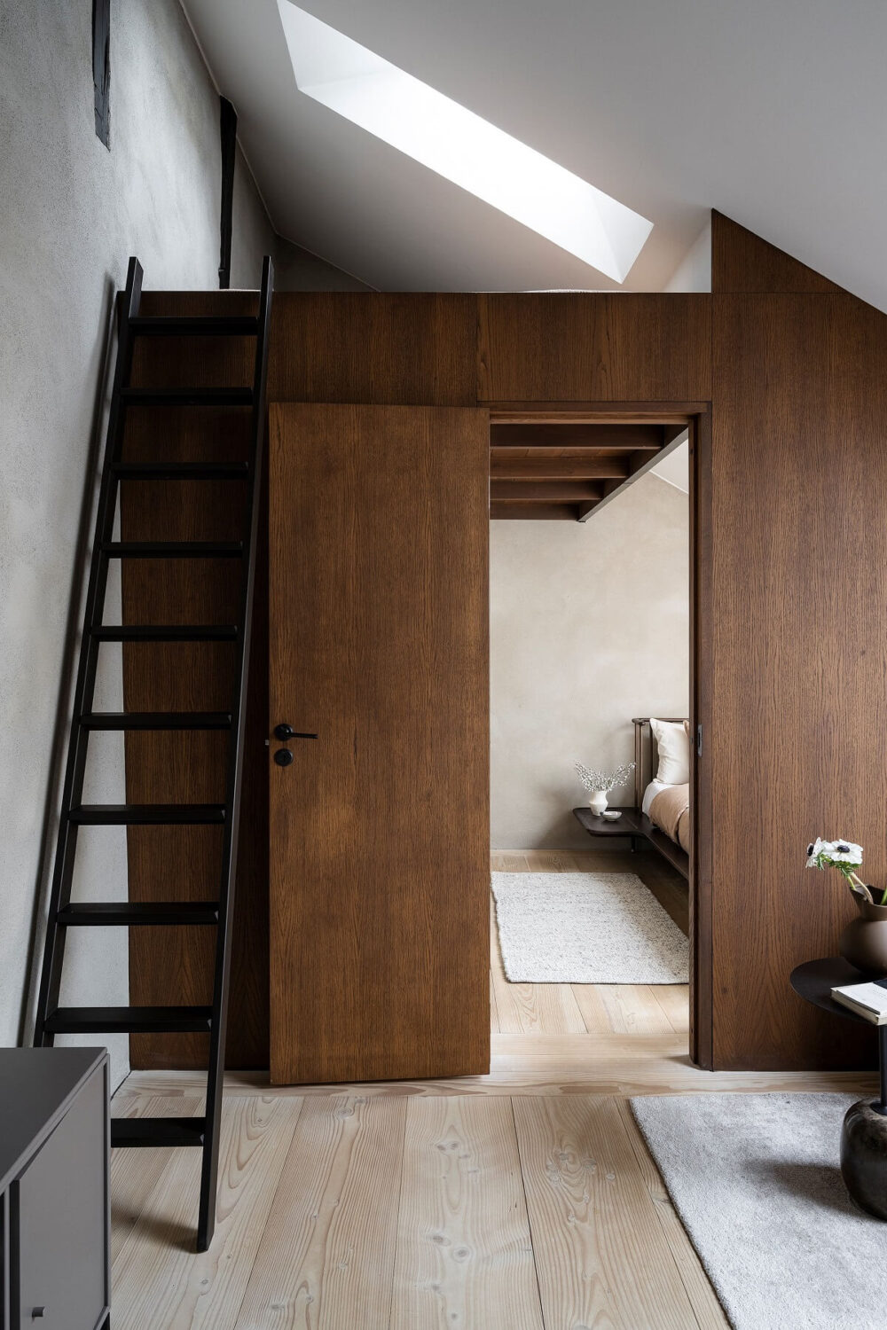 A Stylish Scandinavian Duplex with Custom-Made Cabinets 18 attic floor with wooden feature wall and loft space