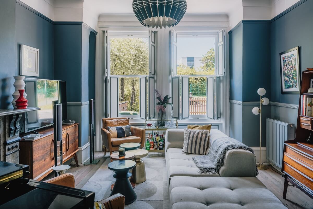 A Deep Blue Color Palette in a London Apartment 1 blue living room with sofa in center of room