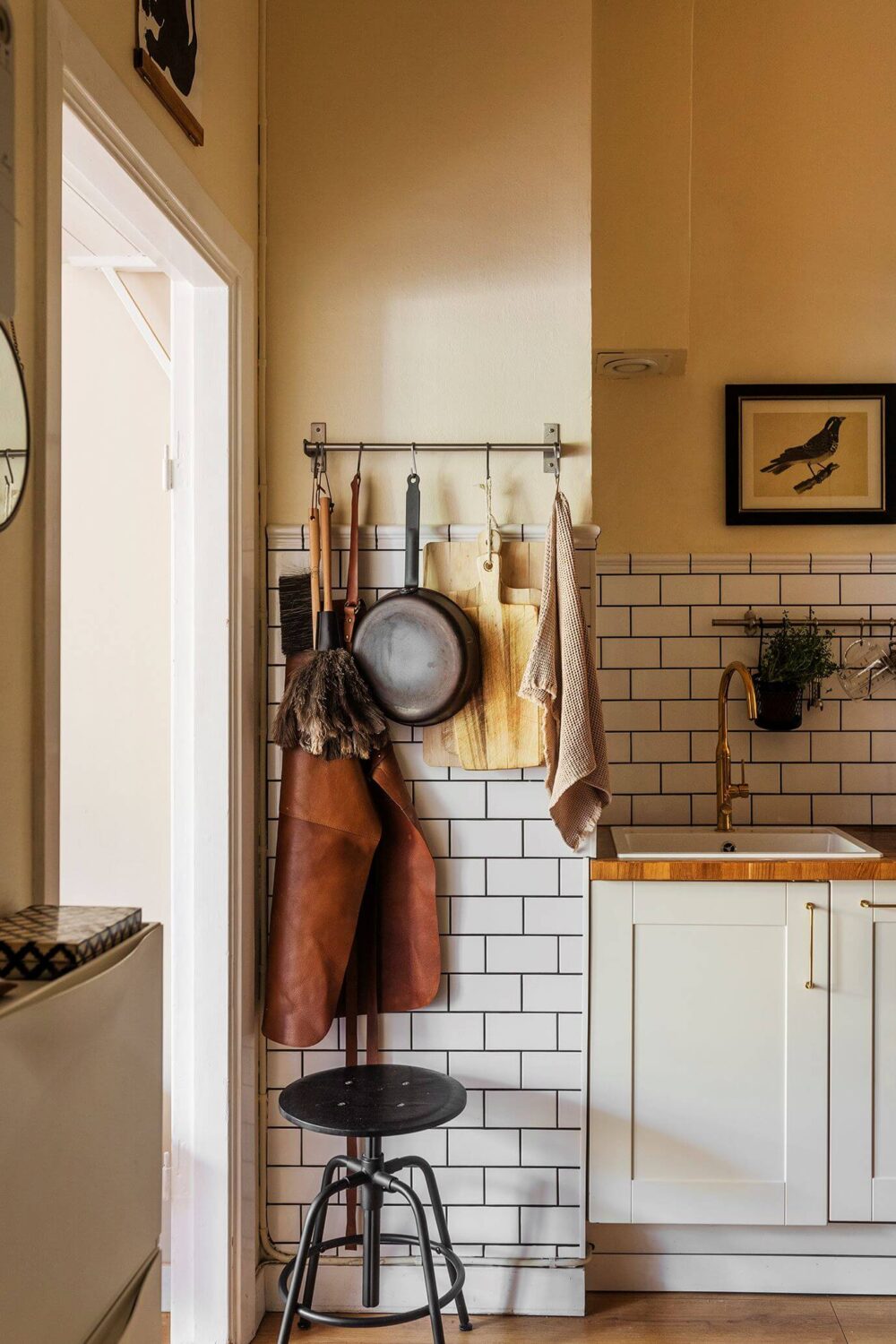 A Charming Studio Apartment with a Loft Bed 8 studio apartment kitchen with white subway tiles