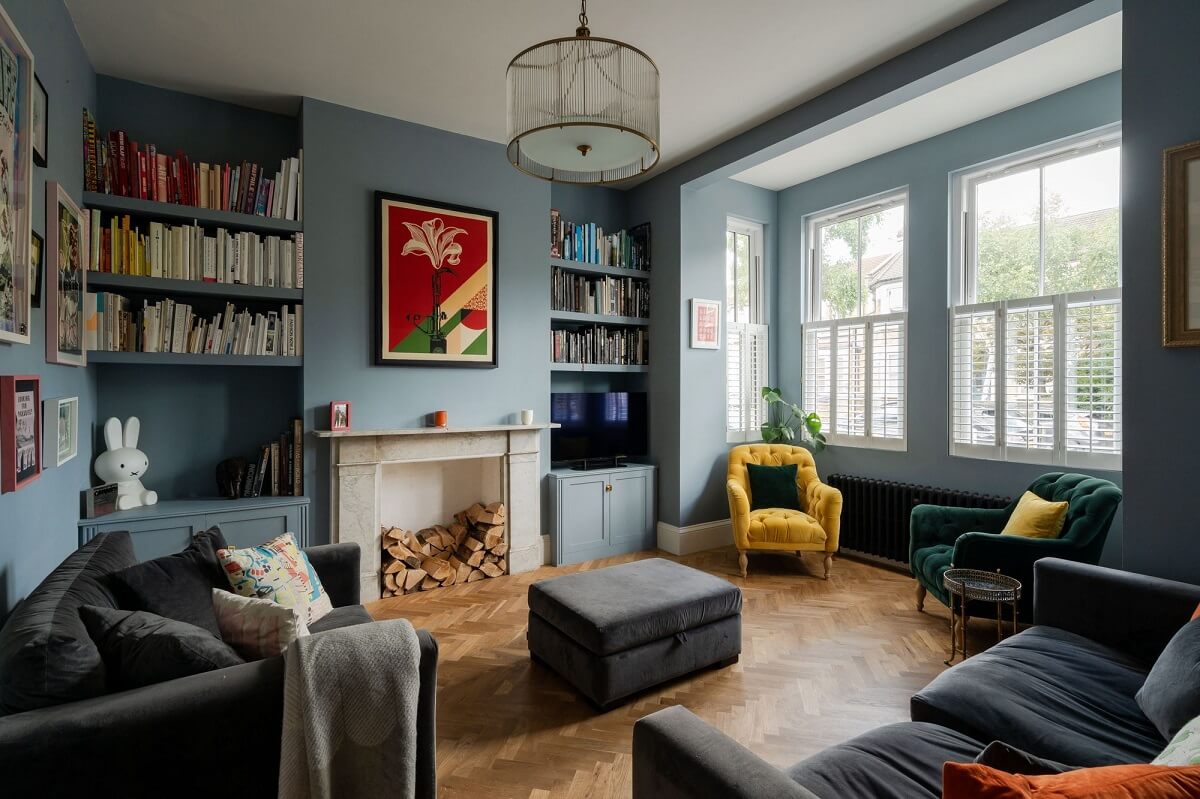 A Stunning Color Palette in an Extended Edwardian House in London 1 blue living room with fireplace and built in bookshelves