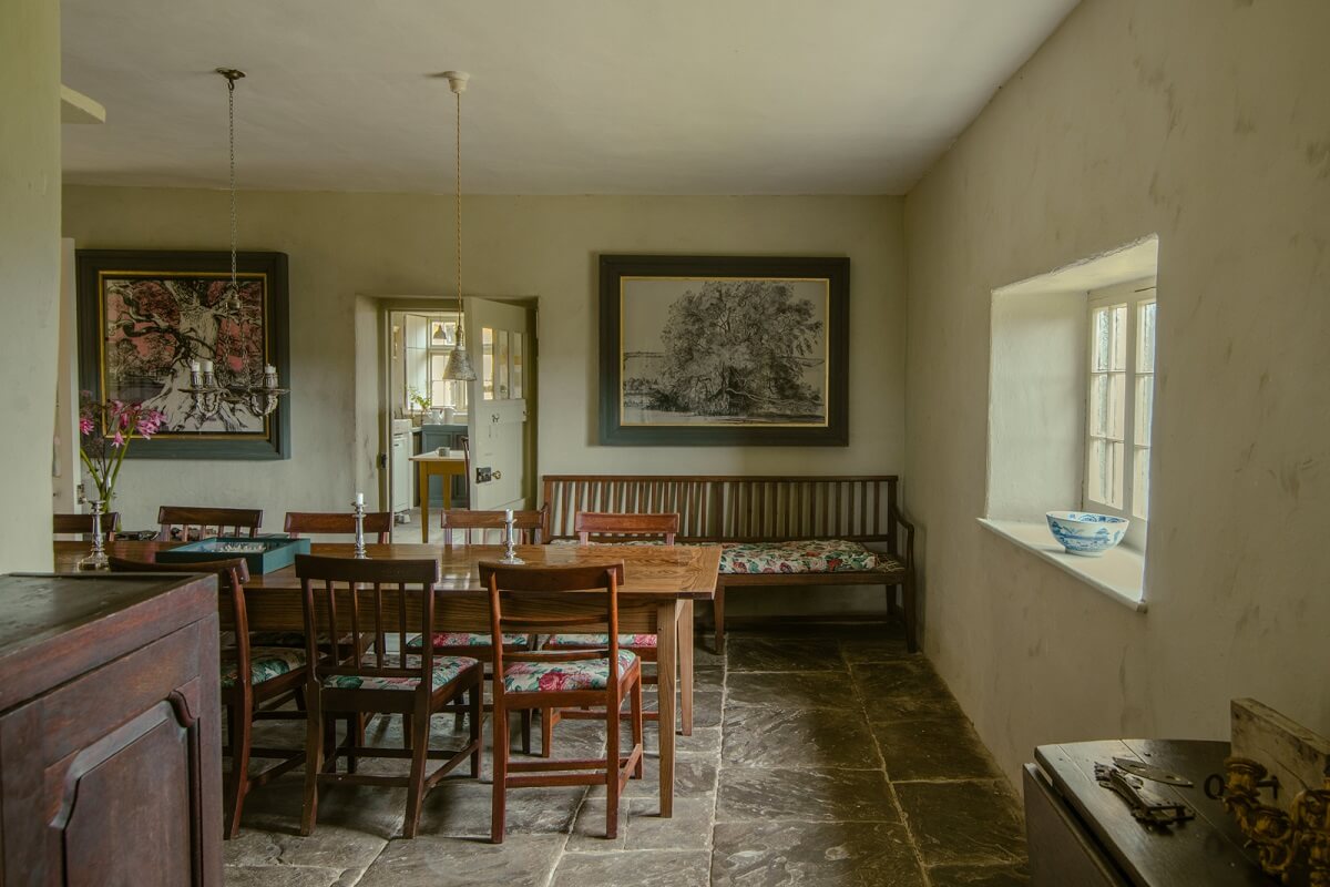 A Yellow Farmhouse with Bold Color Pops in Wales 11 dining room with stone floor