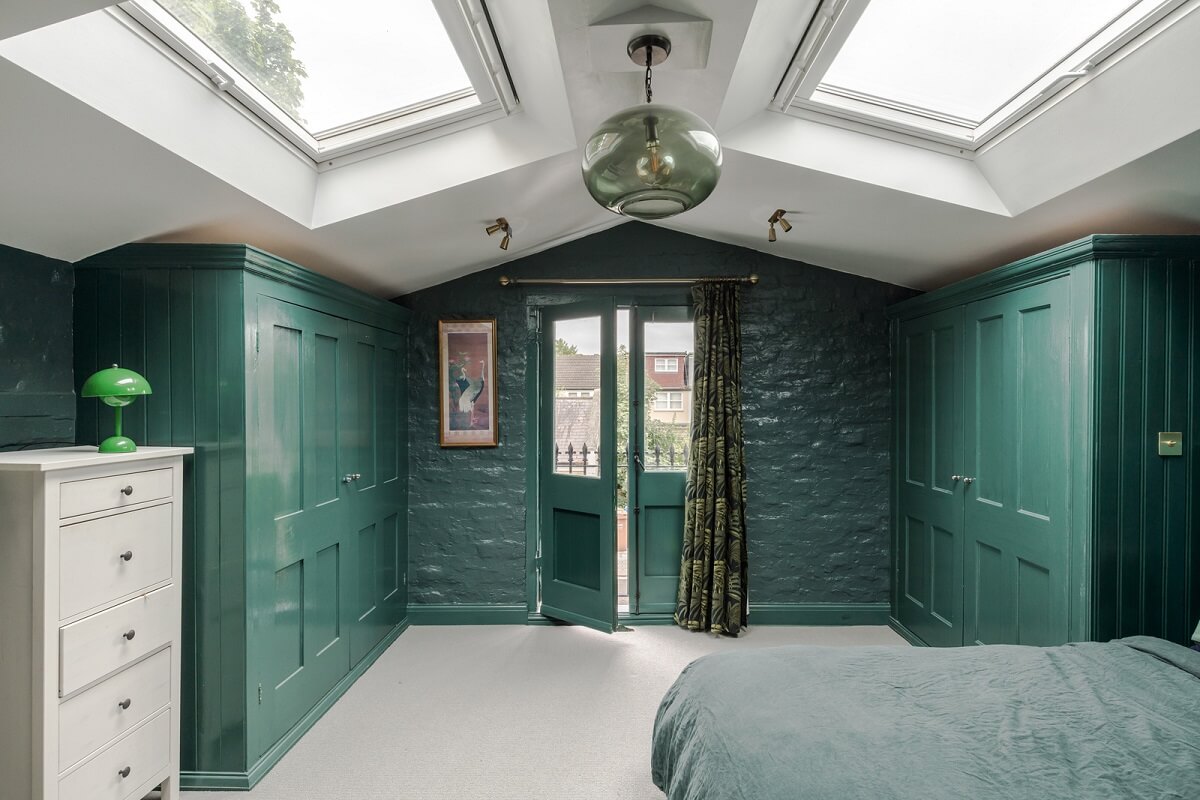 Exposed Materials and Green Tones in a London Stable Conversion 11 green bedroom pitched ceiling skylights
