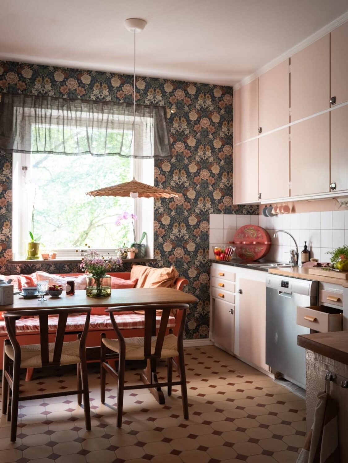 A Two-Bedroom Apartment with the Original Midcentury Kitchen 25 kitchen with pink cabinets floral wallpaper and breakfast table nordroom