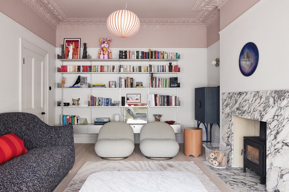 living room pink ceiling bookshelves and marble fireplace nordroom