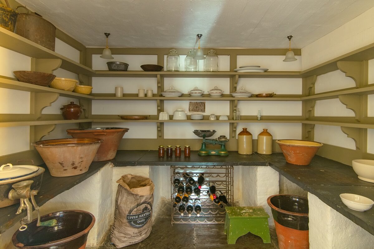 A Yellow Farmhouse with Bold Color Pops in Wales 10 pantry with shelves