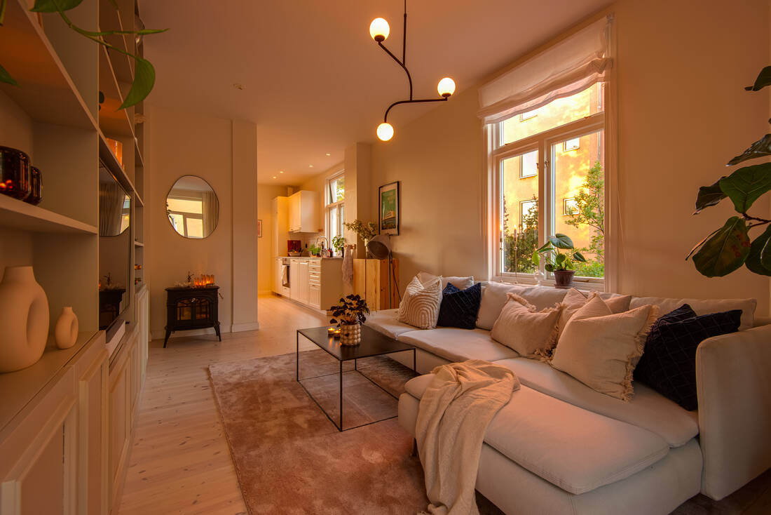 A White Apartment Features a Beautiful Terrace with a View 1 scandinavian apartment evening light