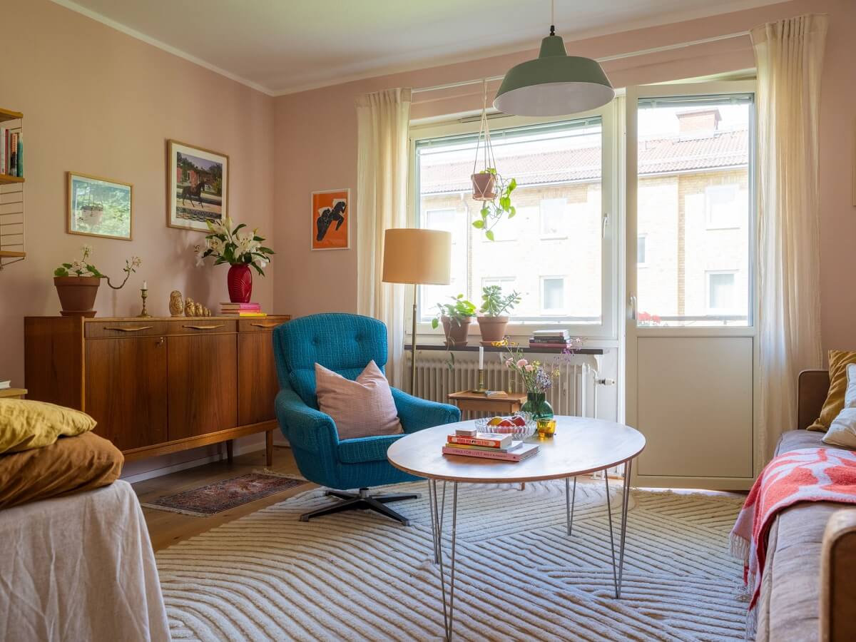 A Studio Apartment with Light Pink Walls and Vintage Furniture 1 studio apartment light pink walls midcentury furniture