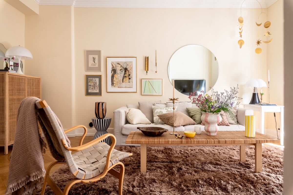 beige walls round mirror living room