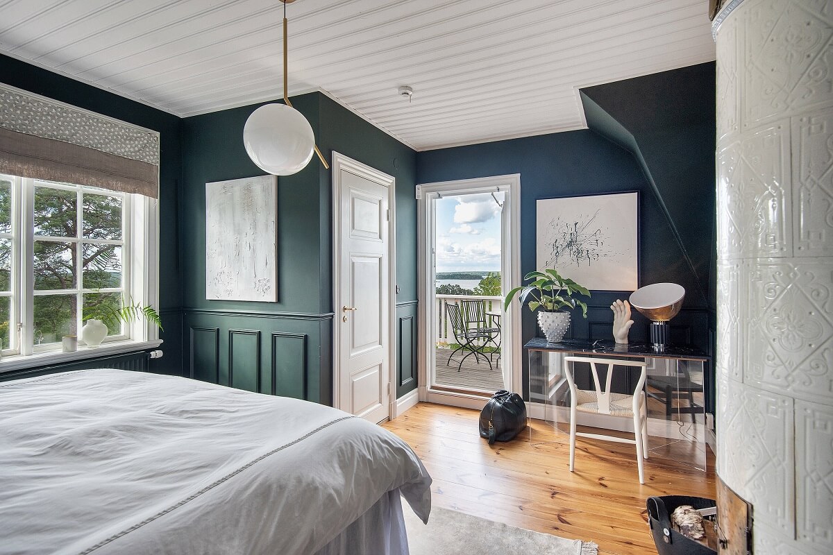 A Yellow Swedish Villa with Views of the Sea 12 dark blue bedroom with balcony