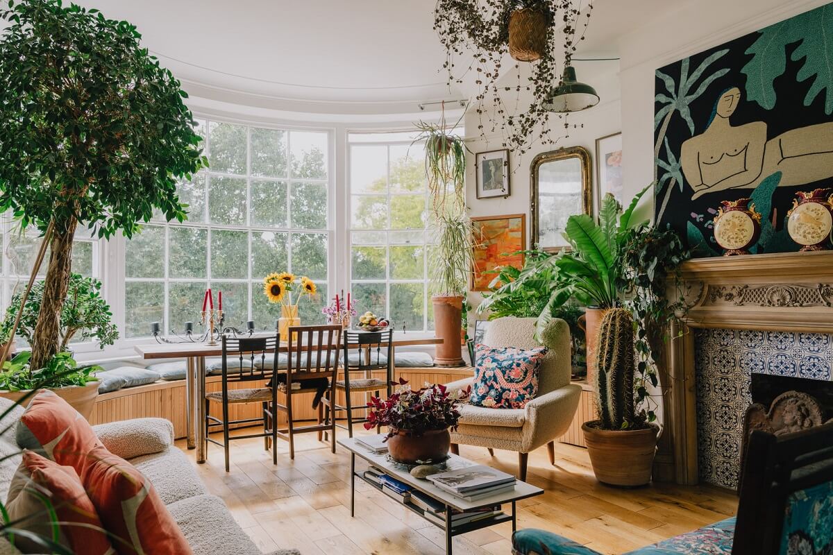 large bay window with built in bench and ornate fireplace living room