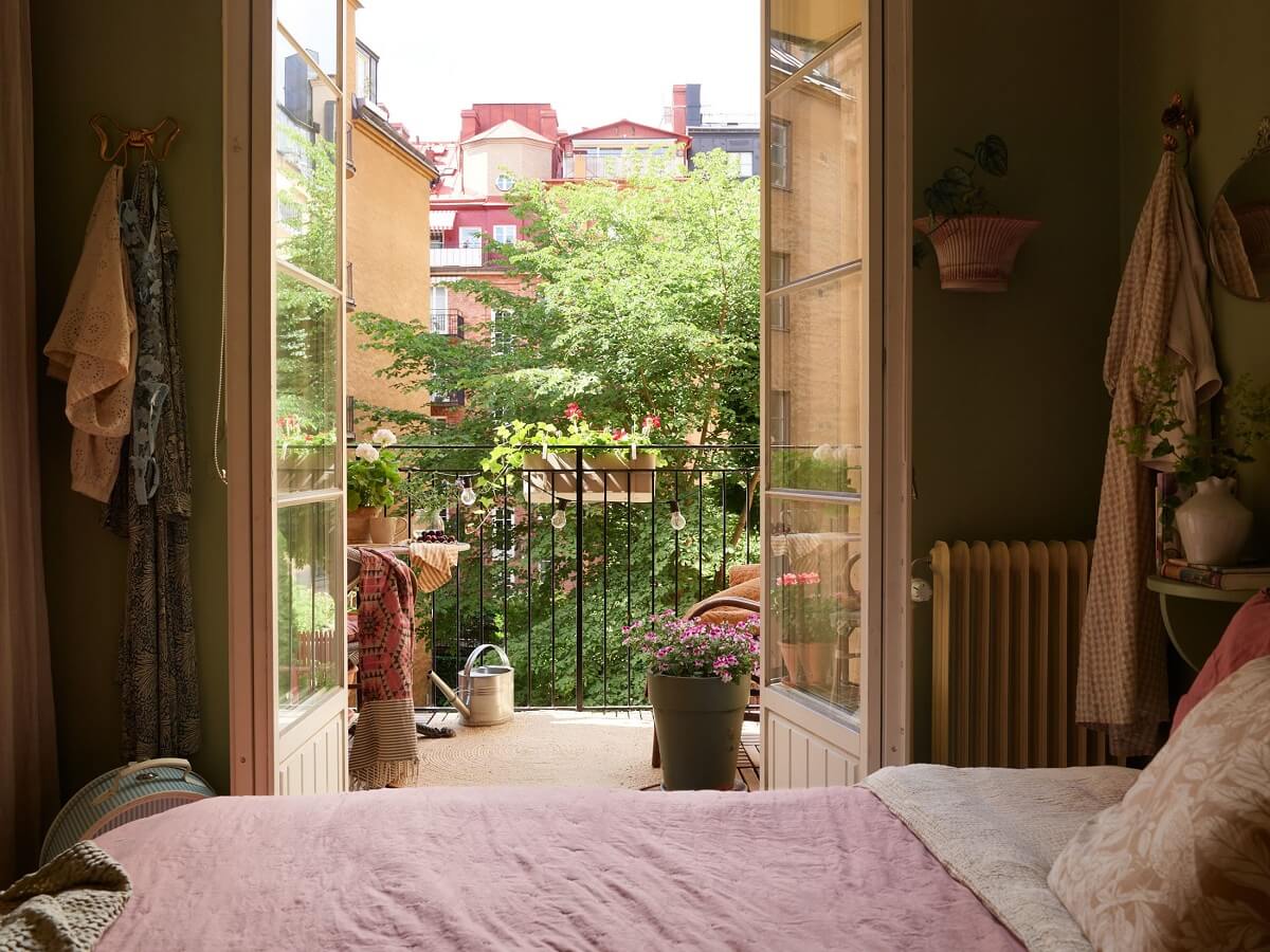 A Cozy 1920s Apartment with Original Details and Wallpaper 20 sage green bedroom with balcony