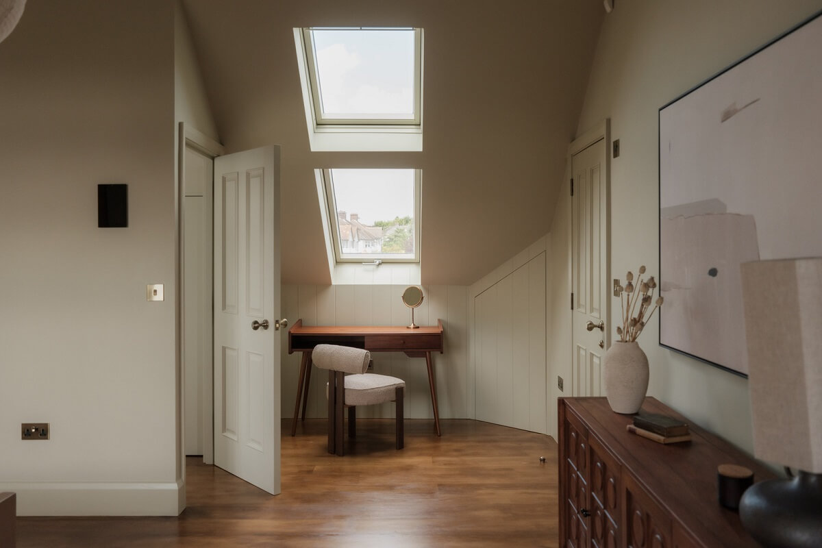 A Calm Color Palette and Warm Materials in a London Home 25 attic bedroom with desk under skylight