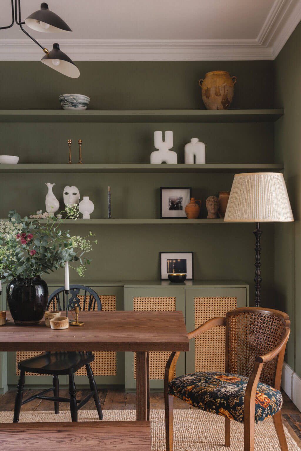 green dining room with wooden table