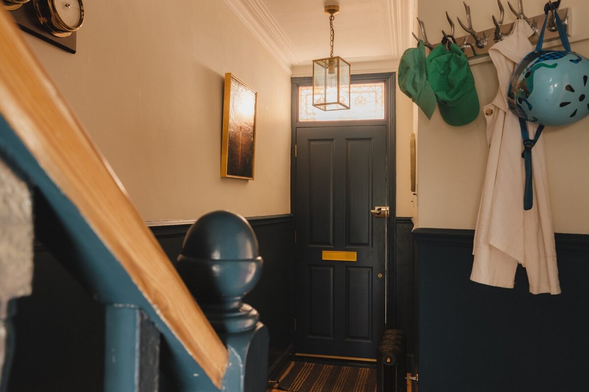 A Charming Victorian House with a Lovely Kitchen 5 hallway with dark blue paneling