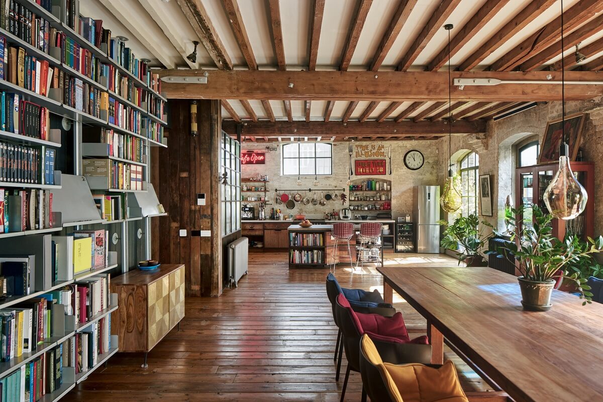 An Industrial and Colorful Warehouse Conversion in London 1 industrial open plan living space exposed beams bookcases