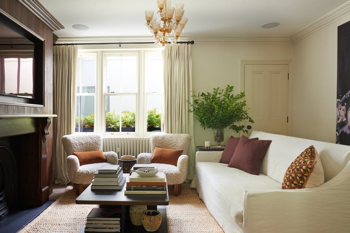 A Luxurious Two-Bedroom Maisonette in Primrose Hill 1 living room with white sofas and fireplace