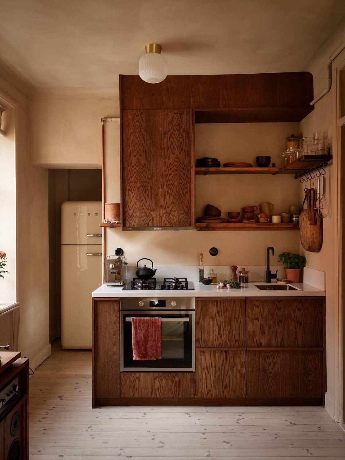 Small Space, Big Style: How to Design a Teeny-Tiny Kitchen That Works 1 small kitchen with walnut cabinets and shelves nordroom