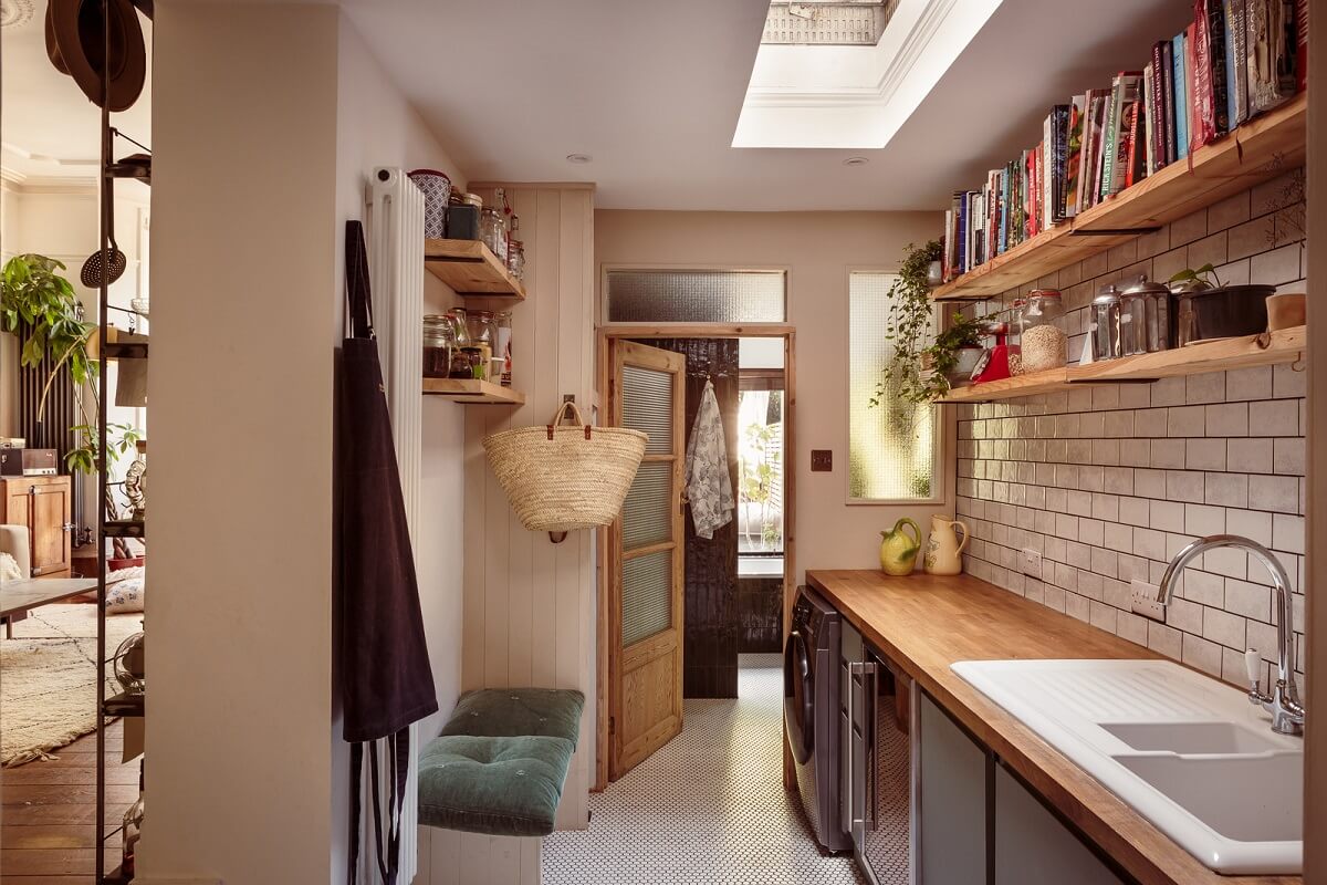 A Warm Ground Floor Apartment with Reclaimed Materials 8 utility room with white brick wall and shelves