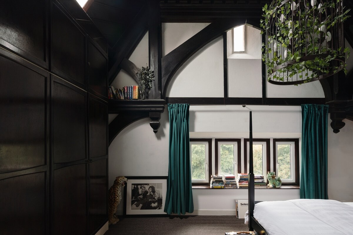 A Colorful Gothic-Style School Conversion in England 10 bedroom dark wooden beams teal curtains