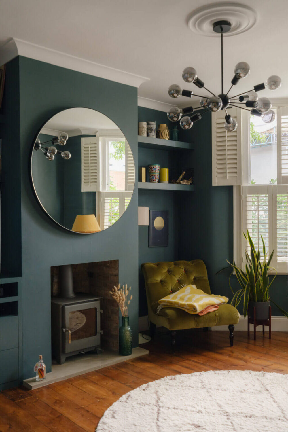 Nature-Inspired Colors in an Extended East London Home 2 blue living room with wood burner and large round mirror