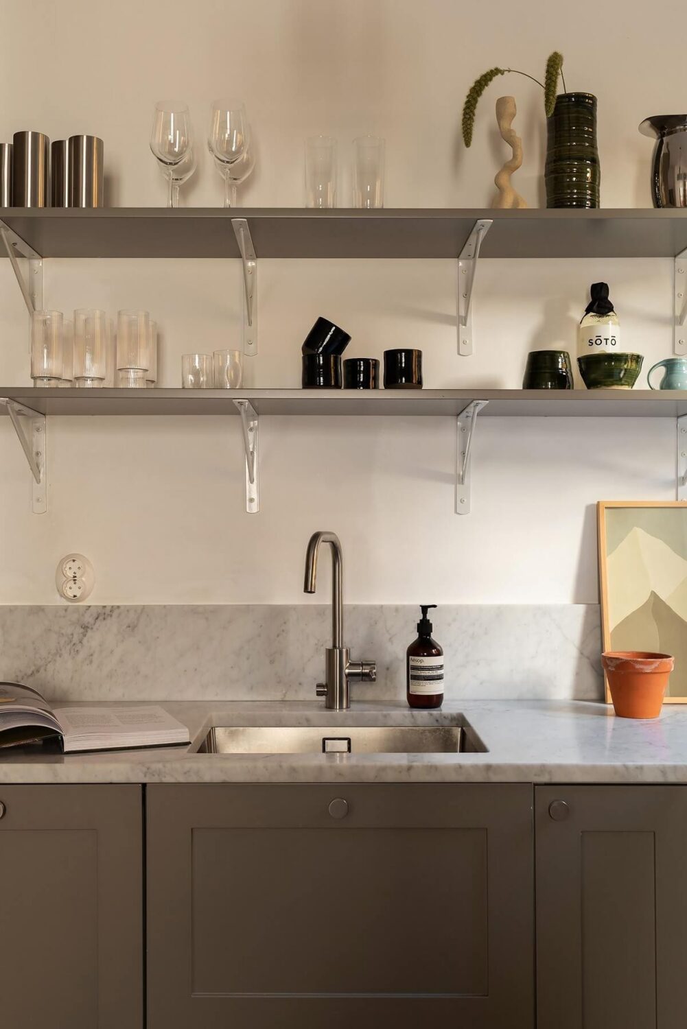 Sober Colors in a Small Renovated Stockholm Apartment 9 gray shaker style cabinets with shelves