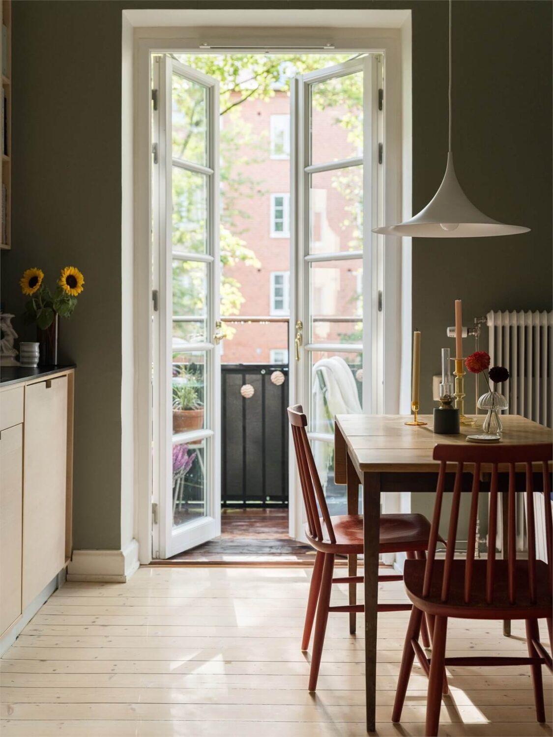 Colorful and Light Rooms in a Swedish One-Bedroom Apartment 10 green kitchen with wooden dining table nordroom