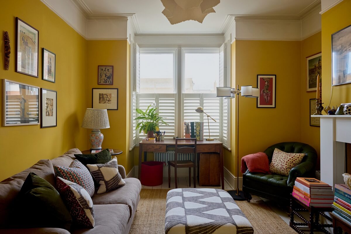 Best of 2024: Living Rooms 19 living room with cheerful yellow walls bay window fireplace