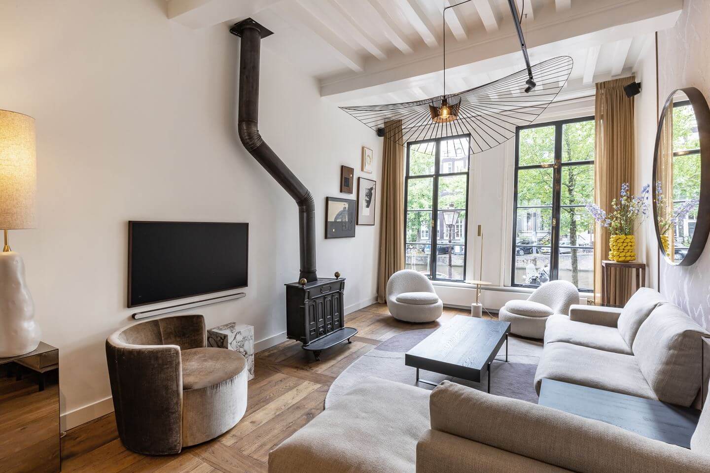 Hotel-Style Interiors in an Amsterdam Canal House 2 living room wooden ceiling woodburner