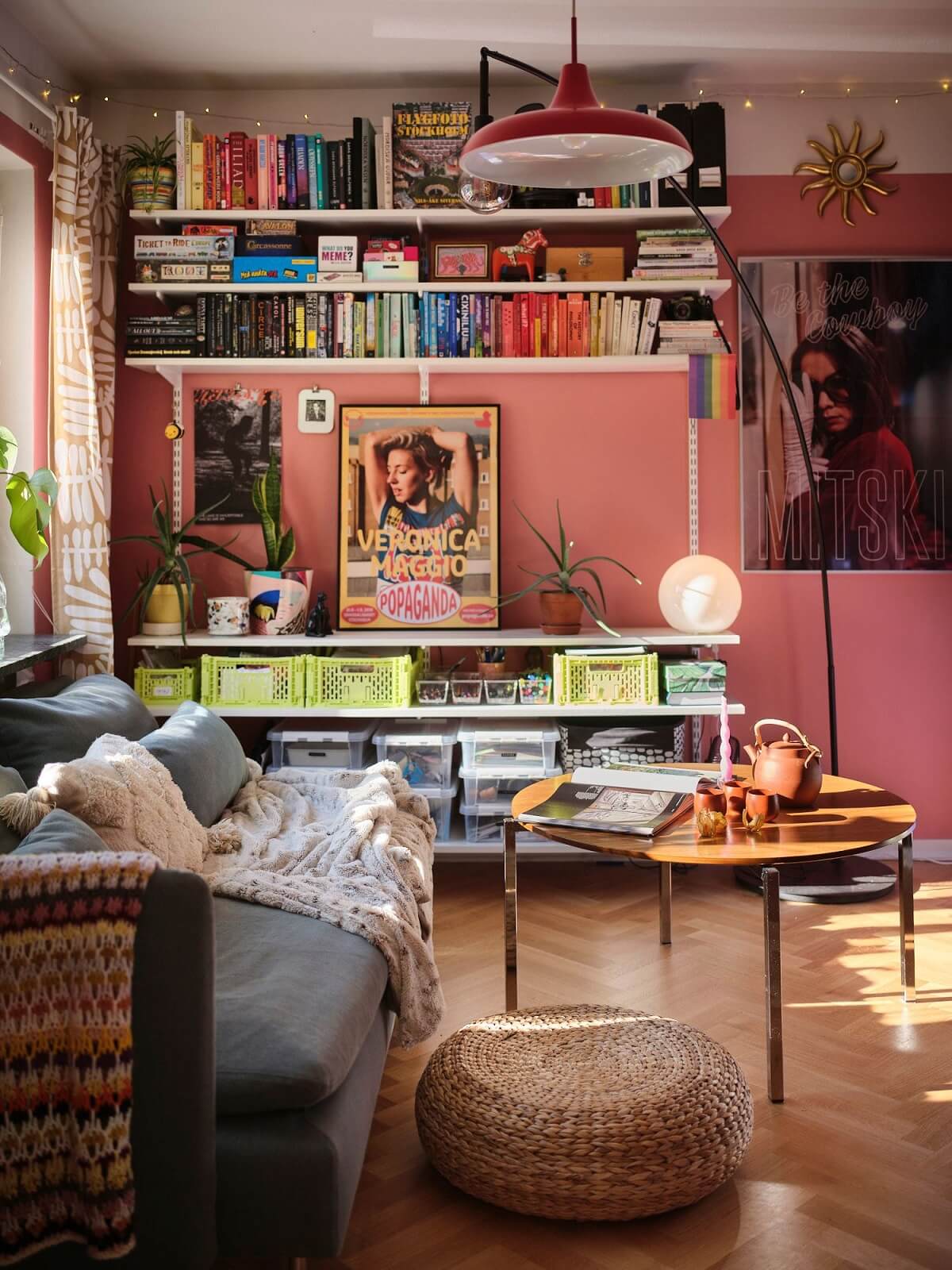 pink walls studio apartment with shelves and ikea sofa nordroom
