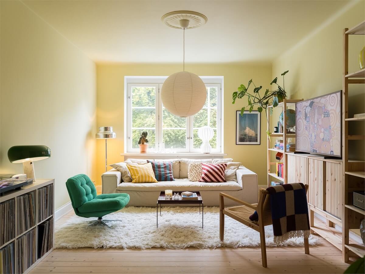 Colorful and Light Rooms in a Swedish One-Bedroom Apartment 1 scandi living room with pastel yellow walls nordroom