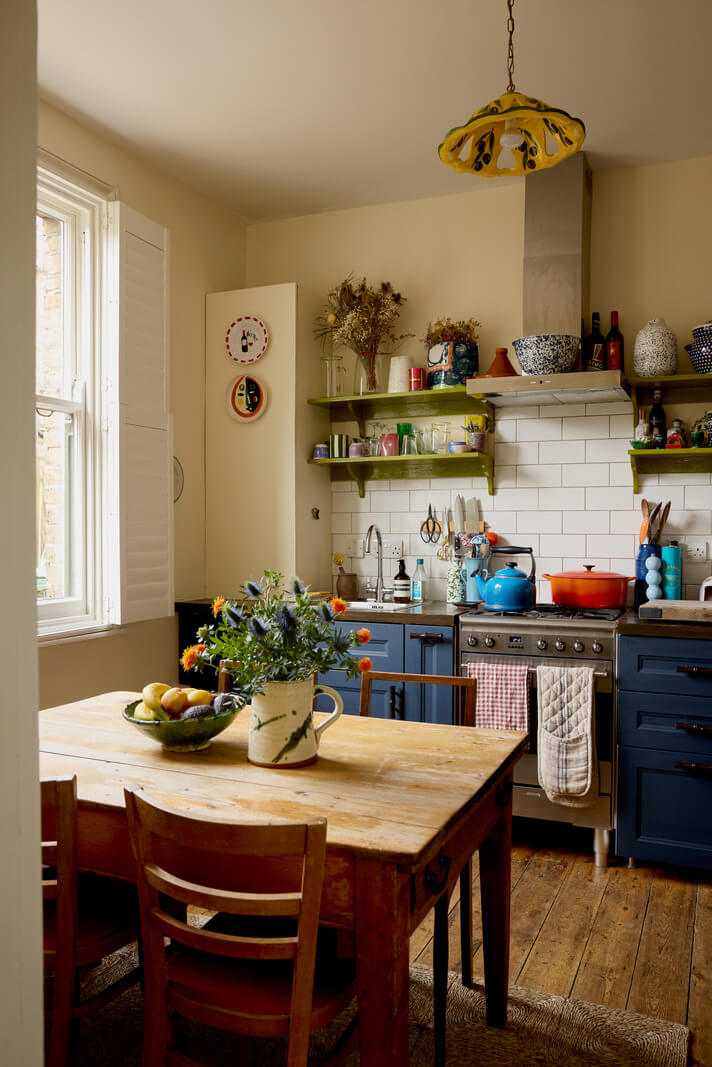 Best of 2024: Kitchens 5 tiny cottage style kitchen with blue cabinets and green shelves nordroom