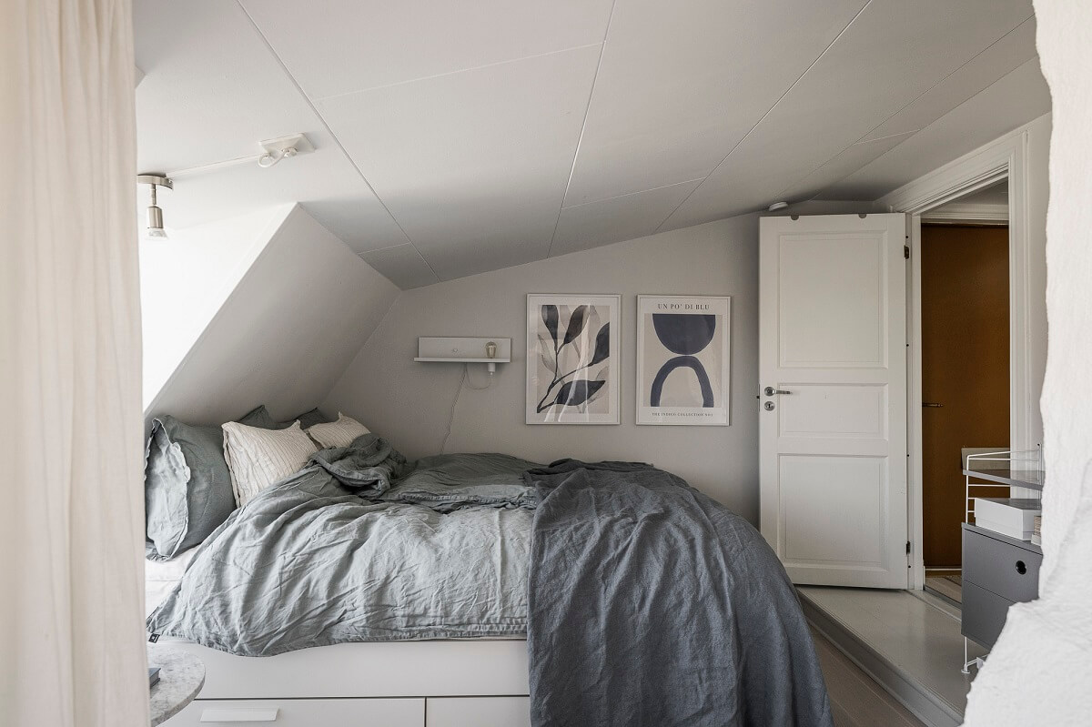 A Swedish Attic Apartment with a Lovely Balcony Overlooking the City 17 attic bedroom low ceiling
