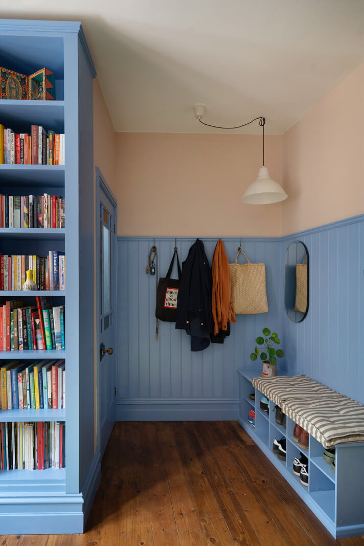 Colorful Rooms and Period Features in a London Terrace House 11 blue hall with storage bench