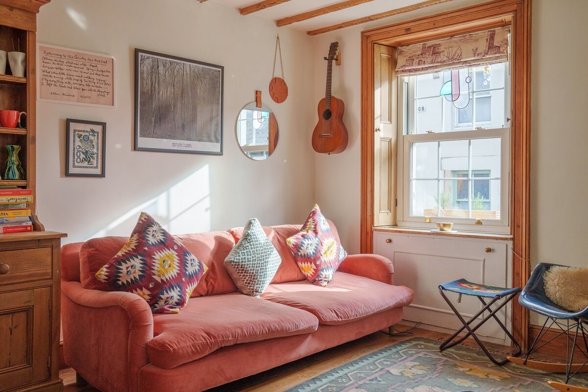 Colorful Furniture in a Historic English Cottage 2 cottage living room with pink couch